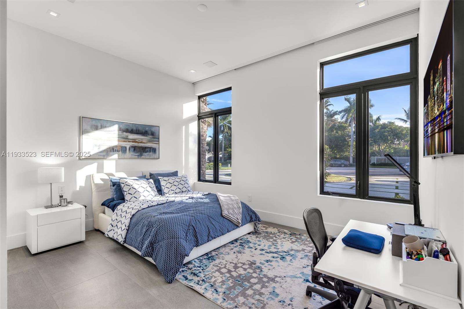 8271 Southwest 67th Street Miami, FL 33143 - Photo 67 of 88 a bedroom with a bed and a table