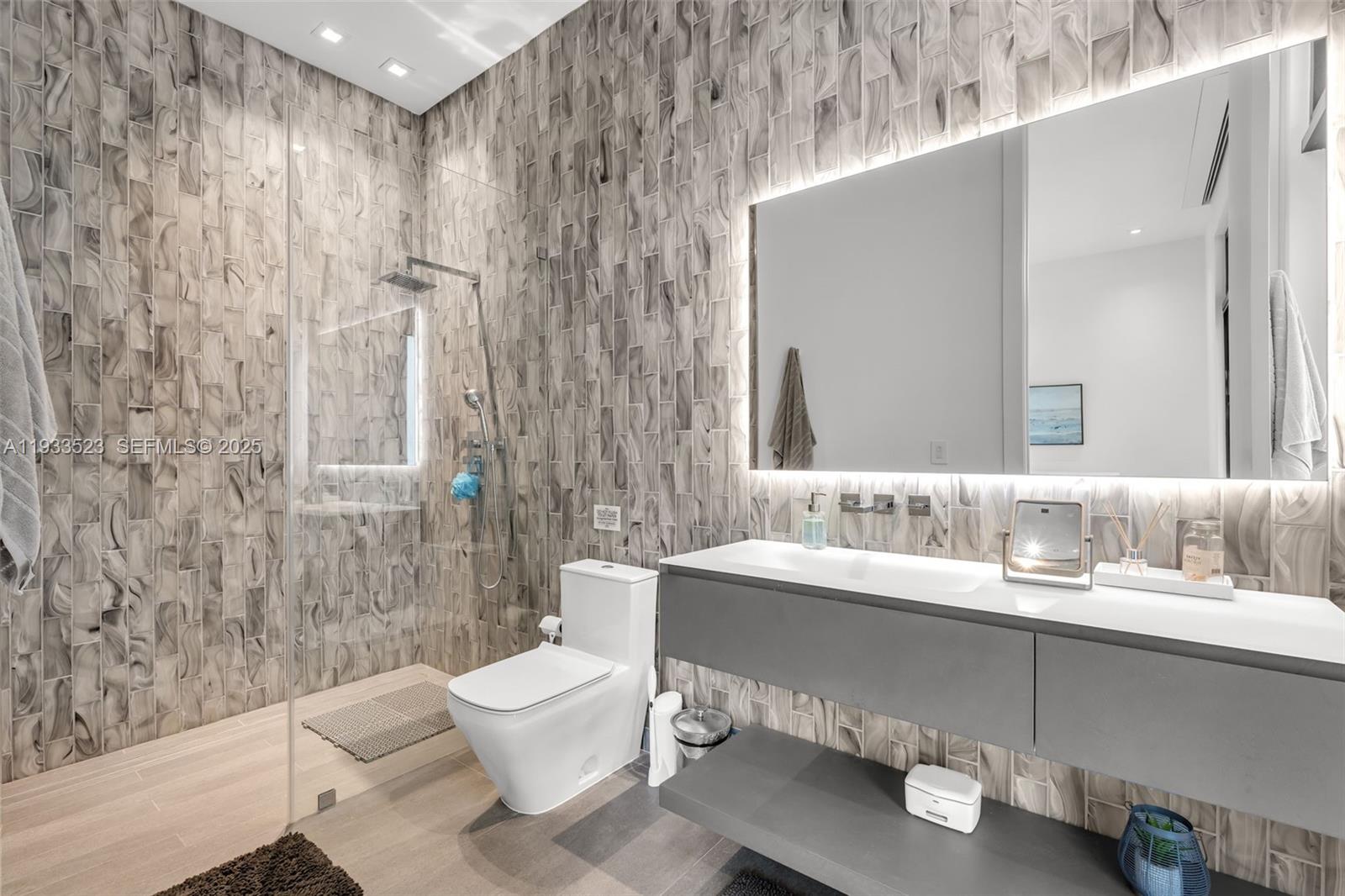 8271 Southwest 67th Street Miami, FL 33143 - Photo 72 of 88 a bathroom with a double vanity sink toilet and shower