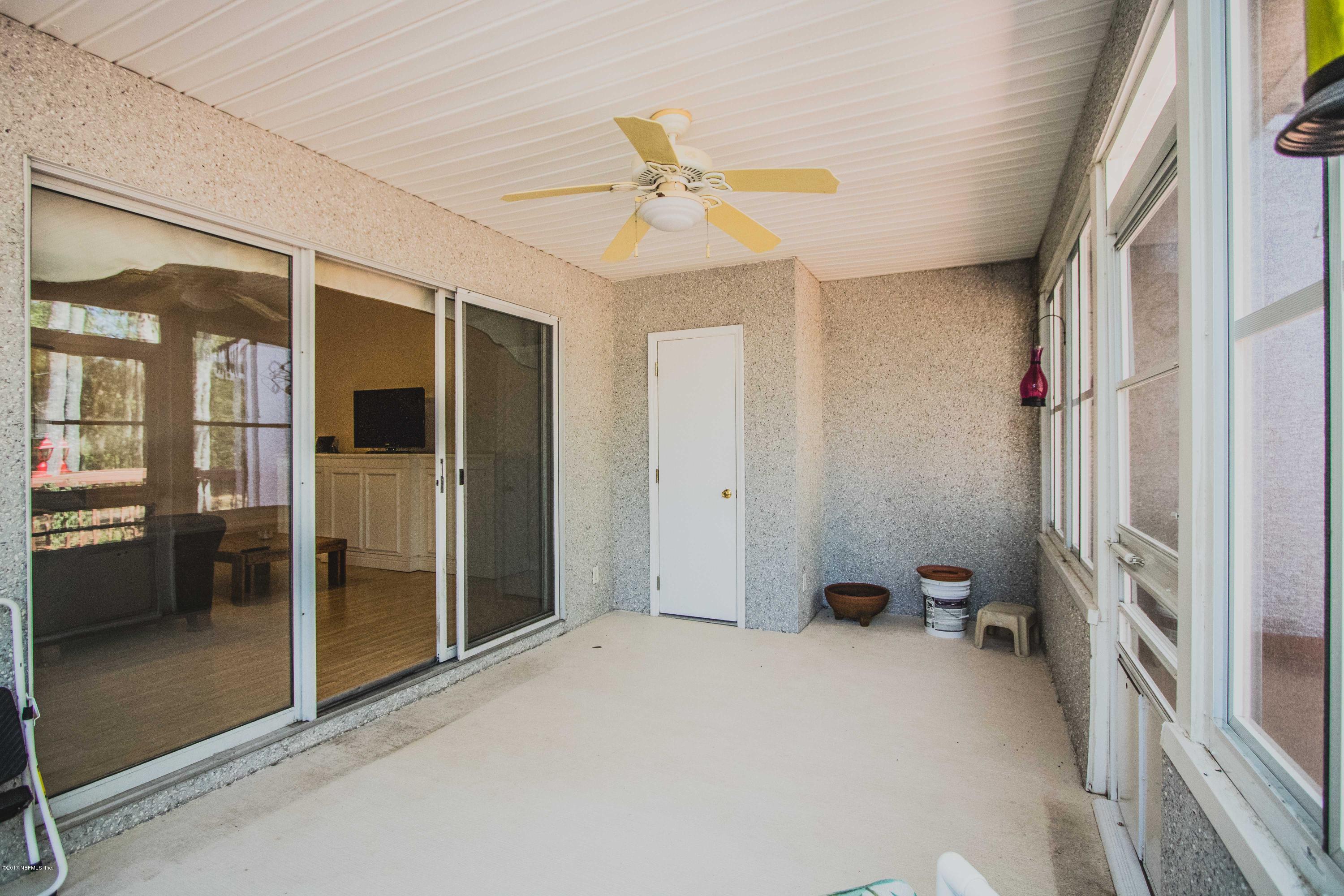 3123 Ravines Road Middleburg, FL 32068 - Photo 25 of 32 a view of a hallway with a chandelier