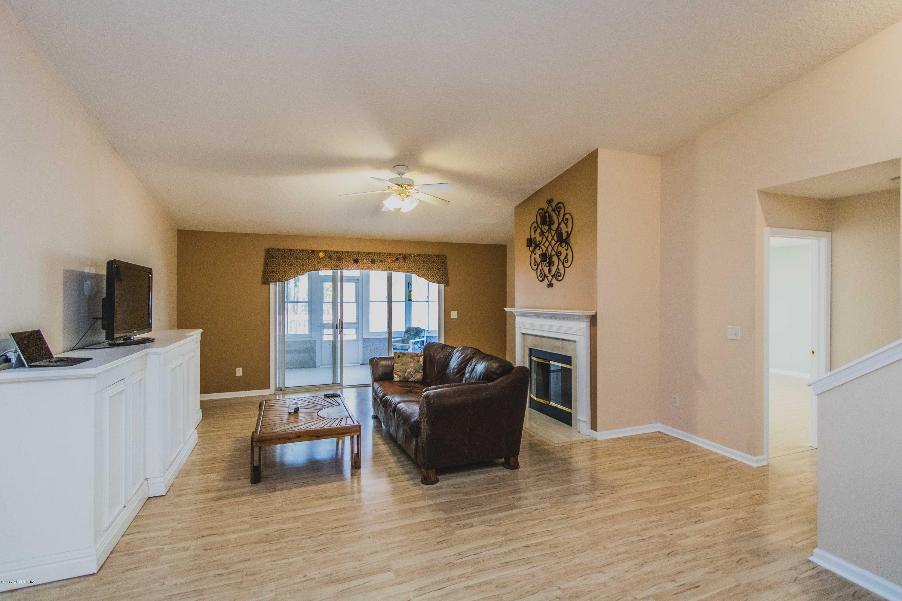 3123 Ravines Road Middleburg, FL 32068 - Photo 4 of 32 a living room with furniture and a flat screen tv