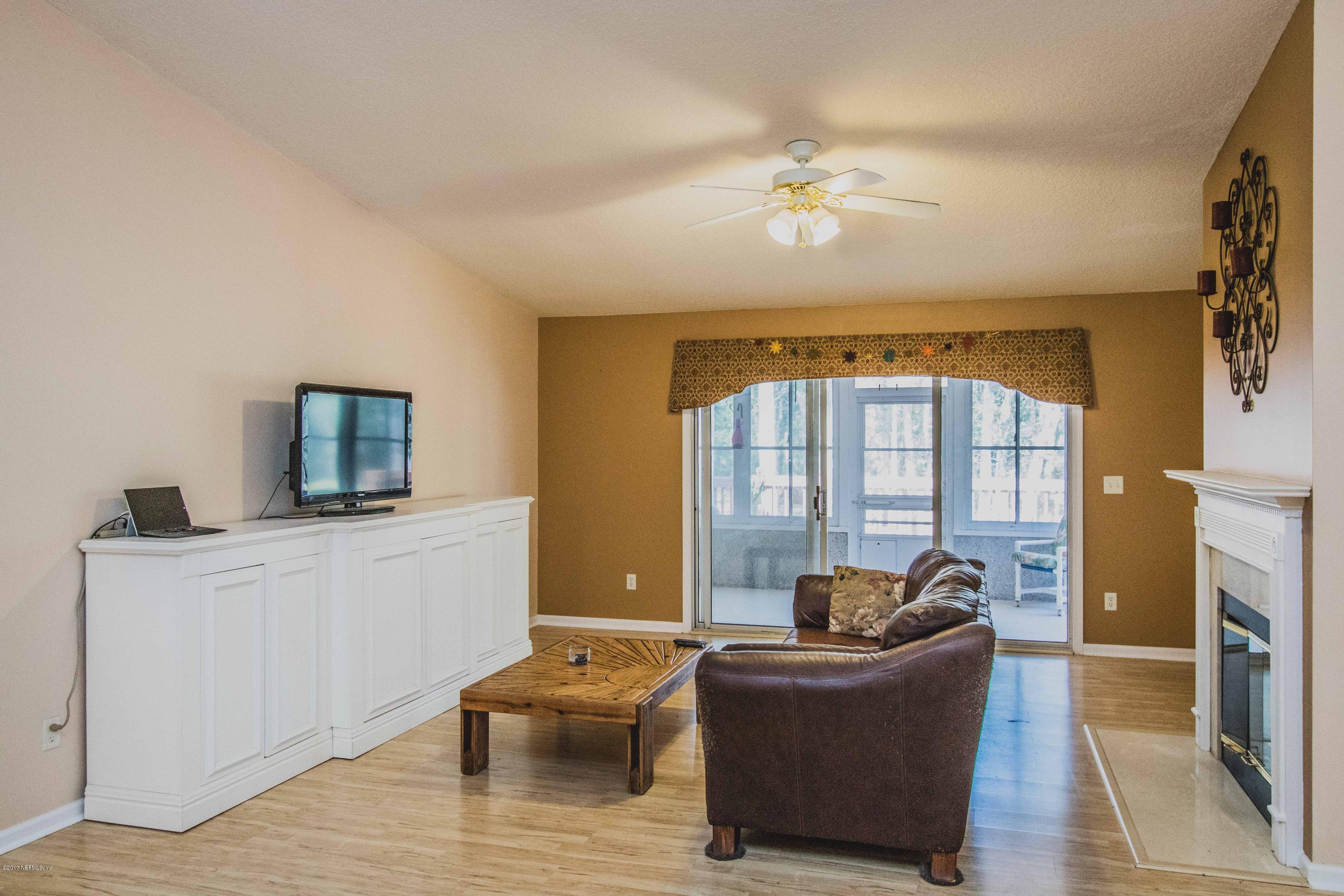 3123 Ravines Road Middleburg, FL 32068 - Photo 5 of 32 a living room with furniture and a fireplace