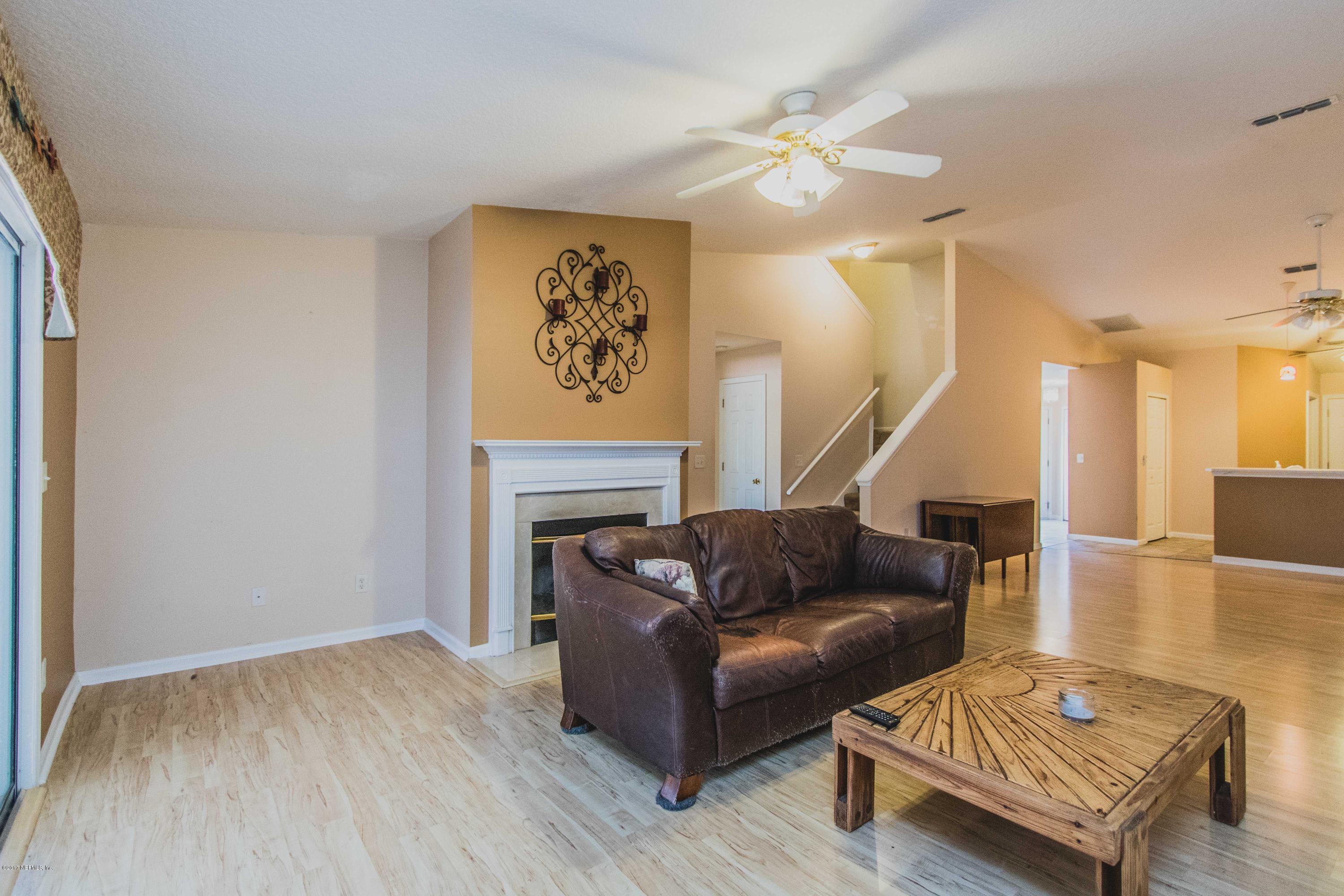 3123 Ravines Road Middleburg, FL 32068 - Photo 6 of 32 a living room with furniture and a wooden floor