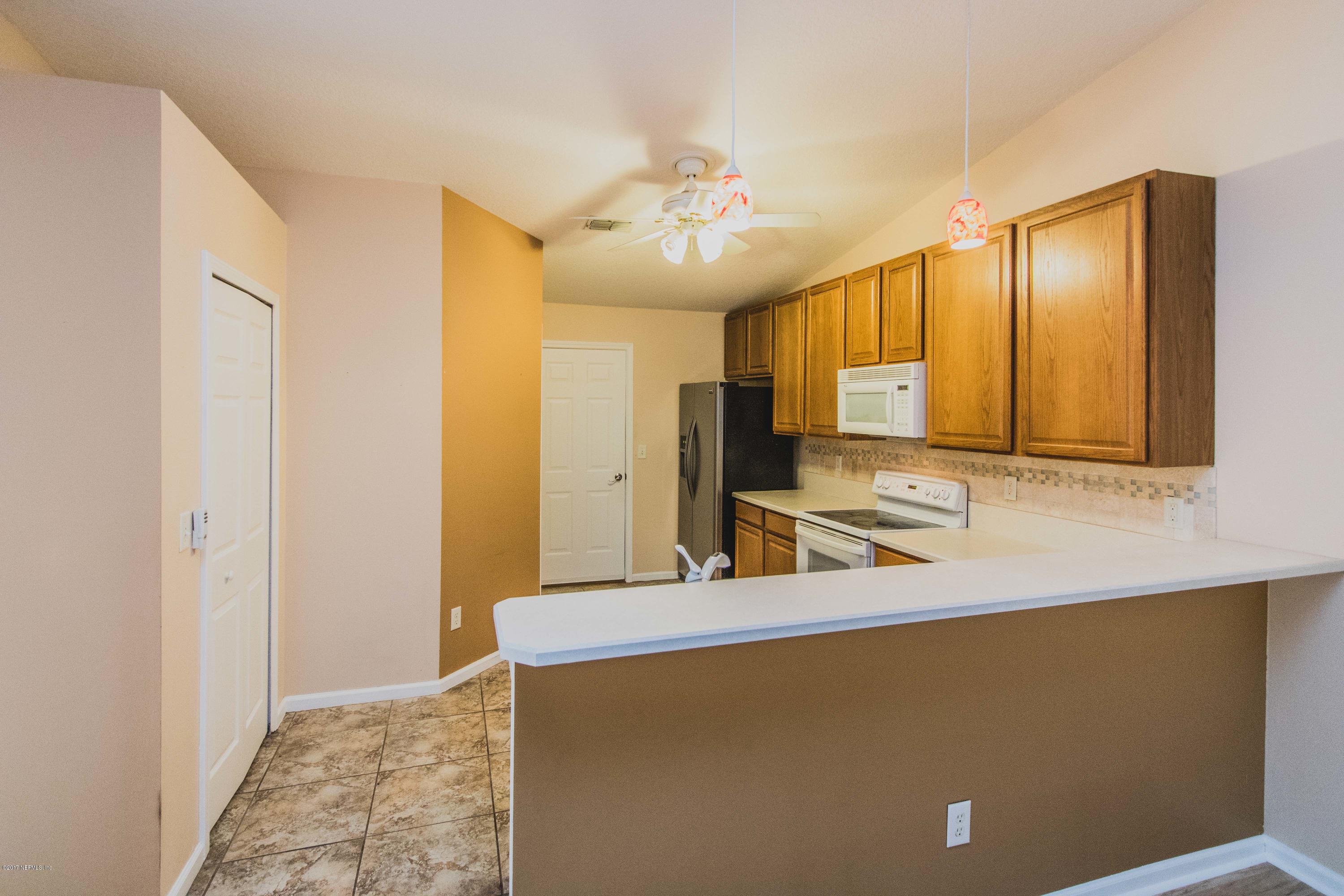 3123 Ravines Road Middleburg, FL 32068 - Photo 8 of 32 a kitchen with stainless steel appliances a sink and a refrigerator