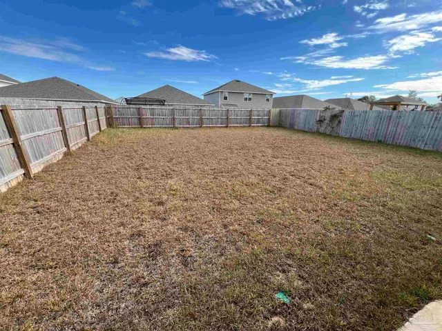 a view of a large house with a big yard and large tree