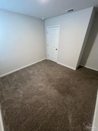 a view of an empty room and entryway