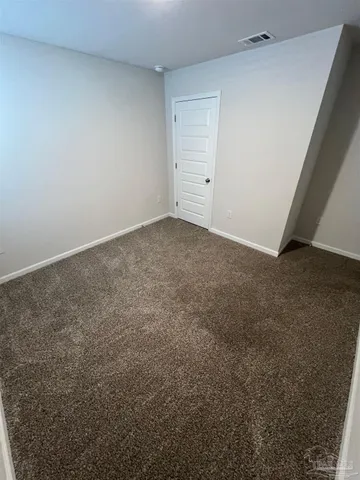 a view of an empty room and entryway