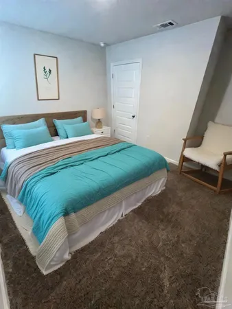 a bed sitting in a bedroom next to a window
