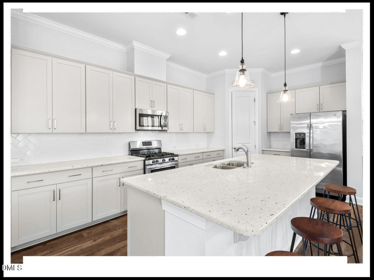 153 Abercorn Circle Chapel Hill, NC 27516 - Photo 20 of 51 a kitchen with a sink a stove a refrigerator and white cabinets with wooden floor