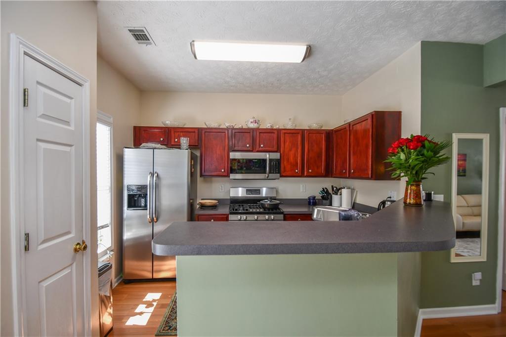 1609 Indian Way Cumming, GA 30040 - Photo 16 of 72 a kitchen with a refrigerator and a sink