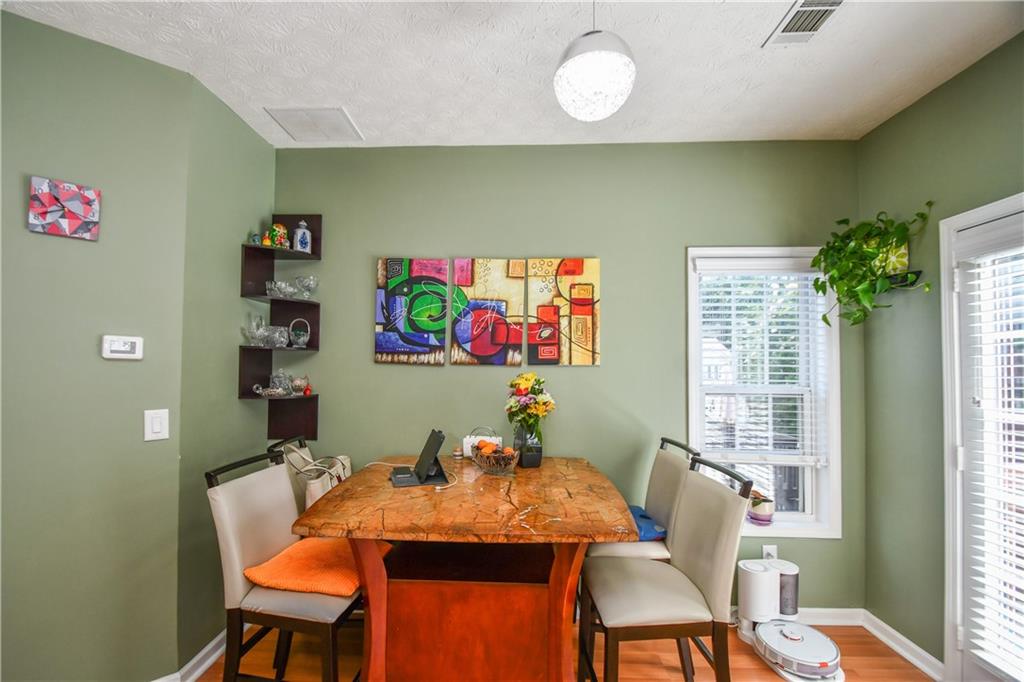 1609 Indian Way Cumming, GA 30040 - Photo 28 of 72 a view of a dining room with furniture and a potted plant