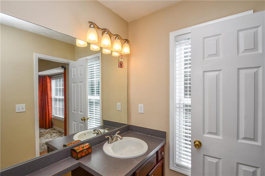 1609 Indian Way Cumming, GA 30040 - Photo 53 of 72 a bathroom with a sink vanity and a mirror