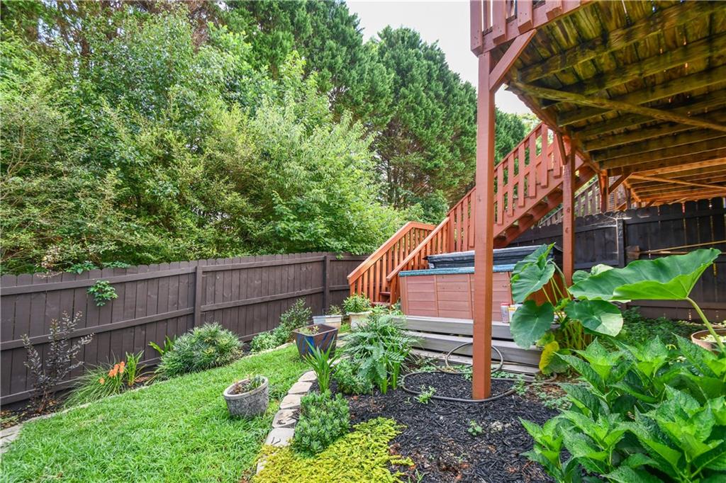 1609 Indian Way Cumming, GA 30040 - Photo 67 of 72 a view of a backyard with plants and a wooden fence
