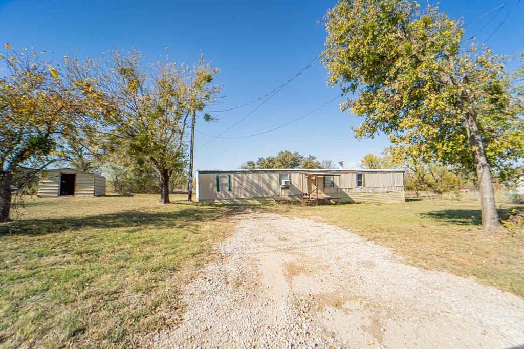 516 South Butte Street Breckenridge, TX 76424 - Photo 1 of 17 a view of a yard covered with snow in front of house