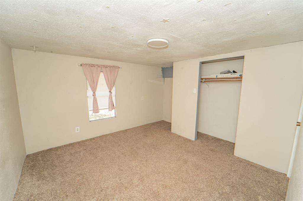 516 South Butte Street Breckenridge, TX 76424 - Photo 12 of 17 an empty room with windows and closet