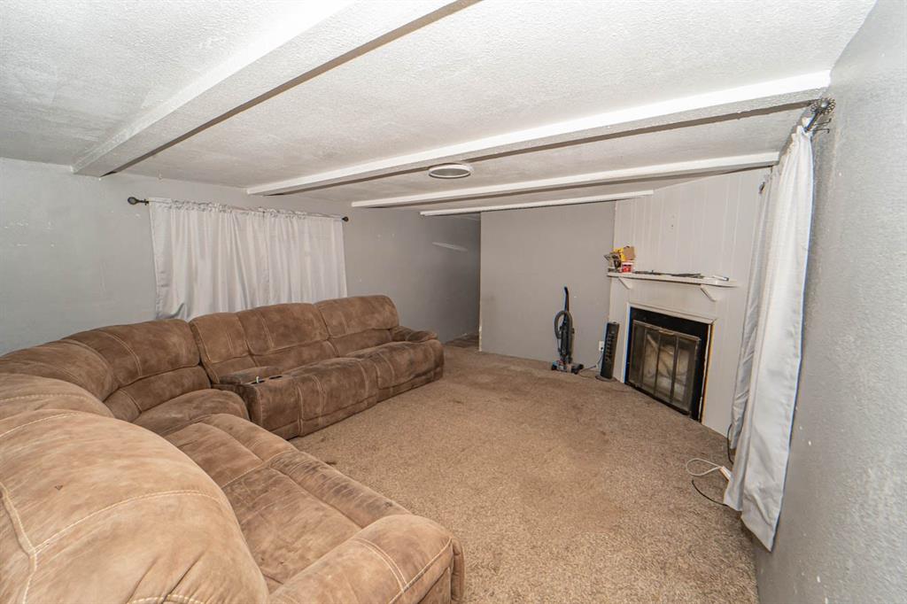 516 South Butte Street Breckenridge, TX 76424 - Photo 16 of 17 a living room with a bed and a fireplace