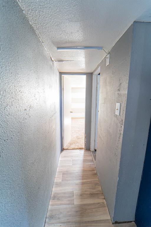 516 South Butte Street Breckenridge, TX 76424 - Photo 7 of 17 a view of a hallway with wooden floor and closet