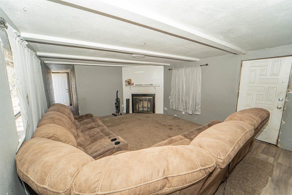 516 South Butte Street Breckenridge, TX 76424 - Photo 9 of 17 a living room with furniture and a fireplace