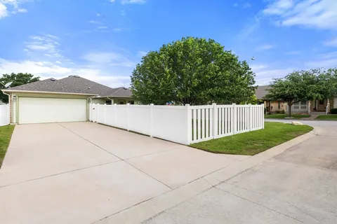 a view of a swimming pool with a lounge chairs in front of a yard