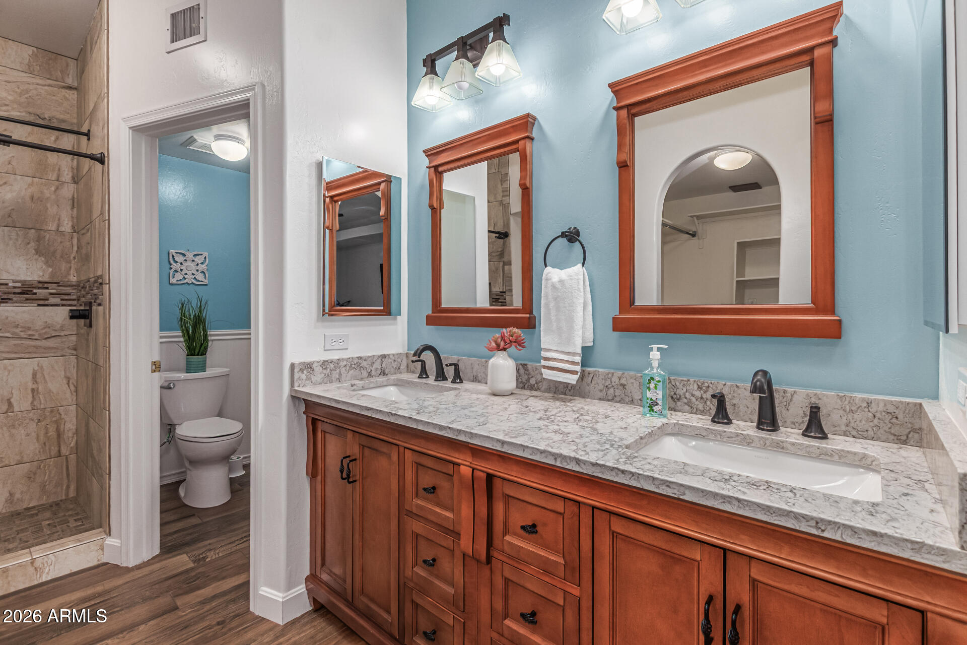 5445 East McKellips Road, Unit 25 Mesa, AZ 85215 - Photo 16 of 32 a bathroom with a granite countertop double vanity sink and a mirror