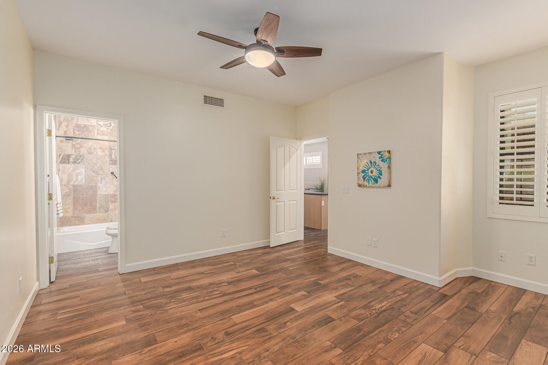 5445 East McKellips Road, Unit 25 Mesa, AZ 85215 - Photo 20 of 32 a view of empty room with wooden floor and fan