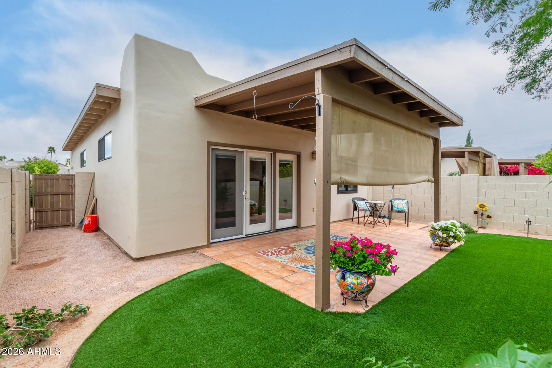 5445 East McKellips Road, Unit 25 Mesa, AZ 85215 - Photo 2 of 32 a front view of a house with a yard and porch