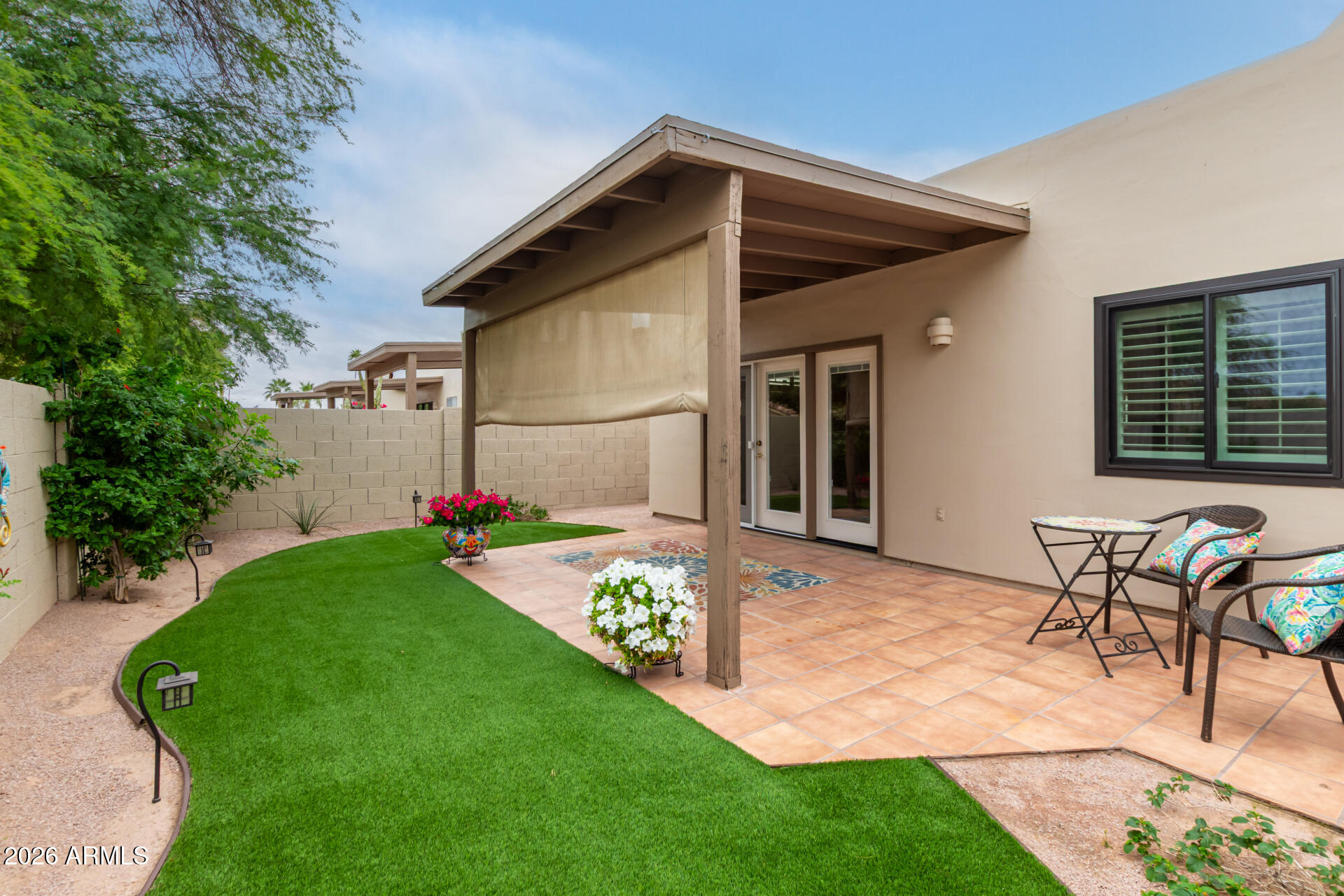 5445 East McKellips Road, Unit 25 Mesa, AZ 85215 - Photo 25 of 32 a view of a chair and table in backyard of the house
