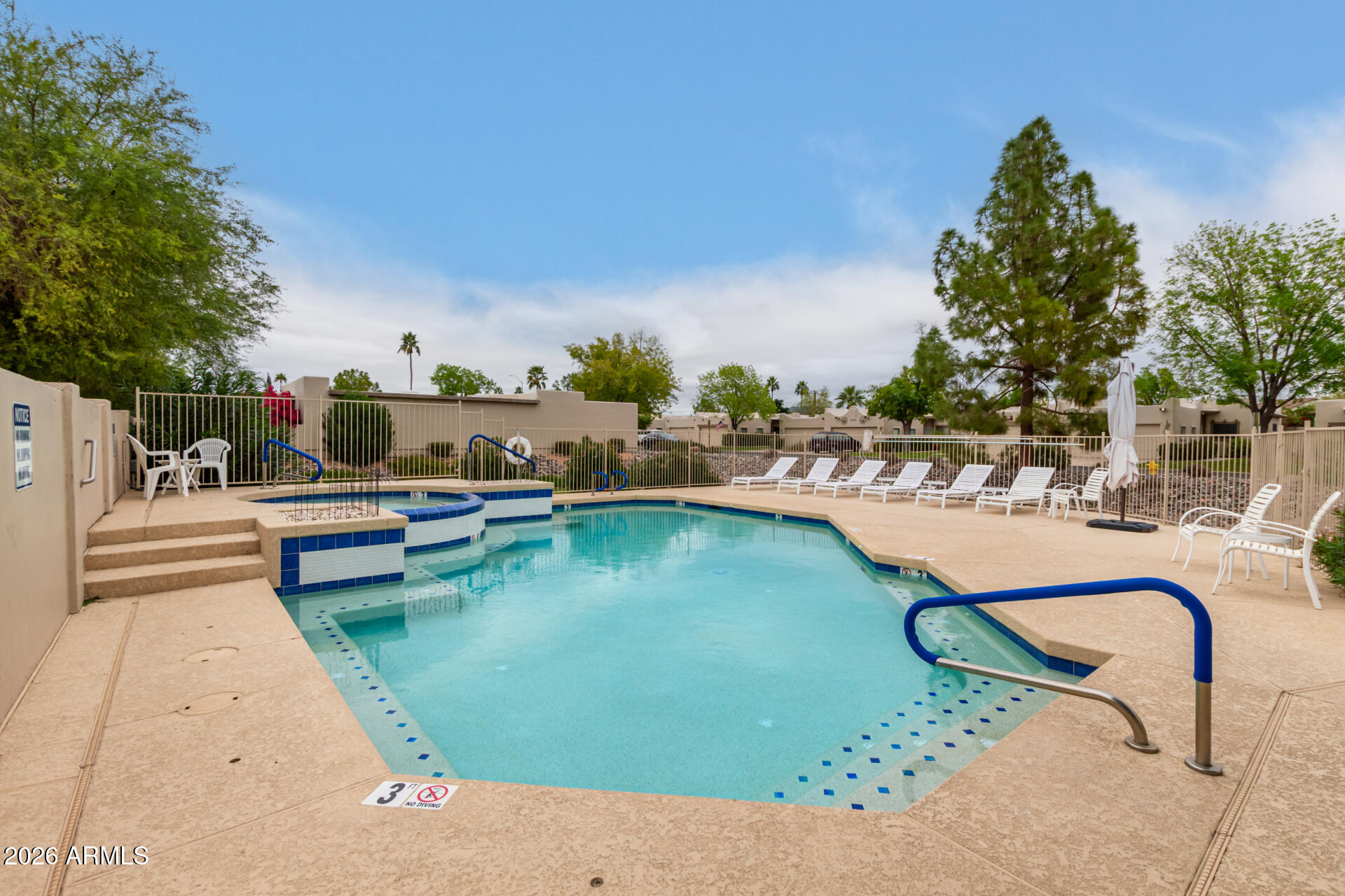 5445 East McKellips Road, Unit 25 Mesa, AZ 85215 - Photo 29 of 32 a swimming pool with outdoor seating and yard