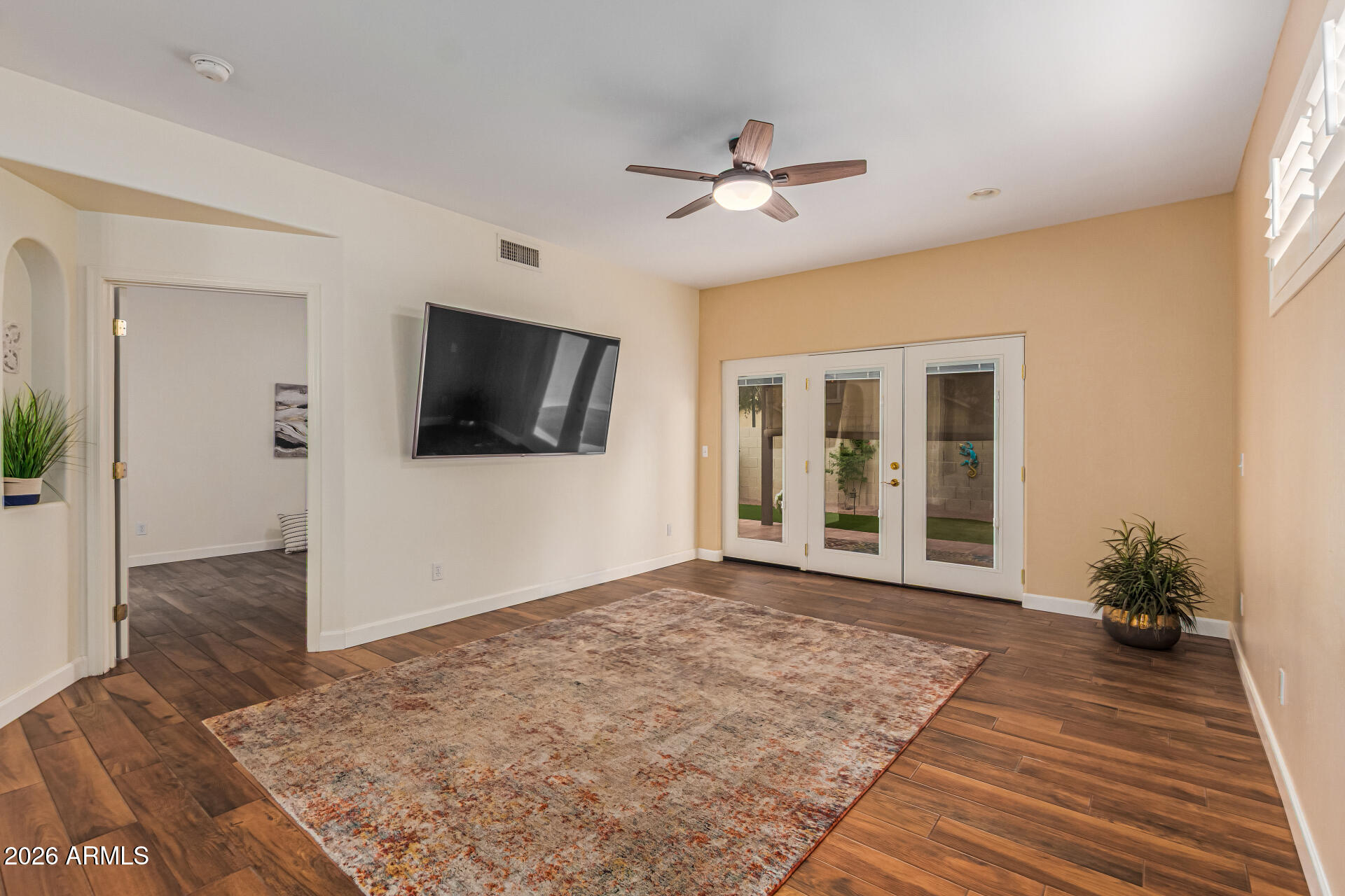 5445 East McKellips Road, Unit 25 Mesa, AZ 85215 - Photo 4 of 32 a view of a livingroom with wooden floor and a flat screen tv