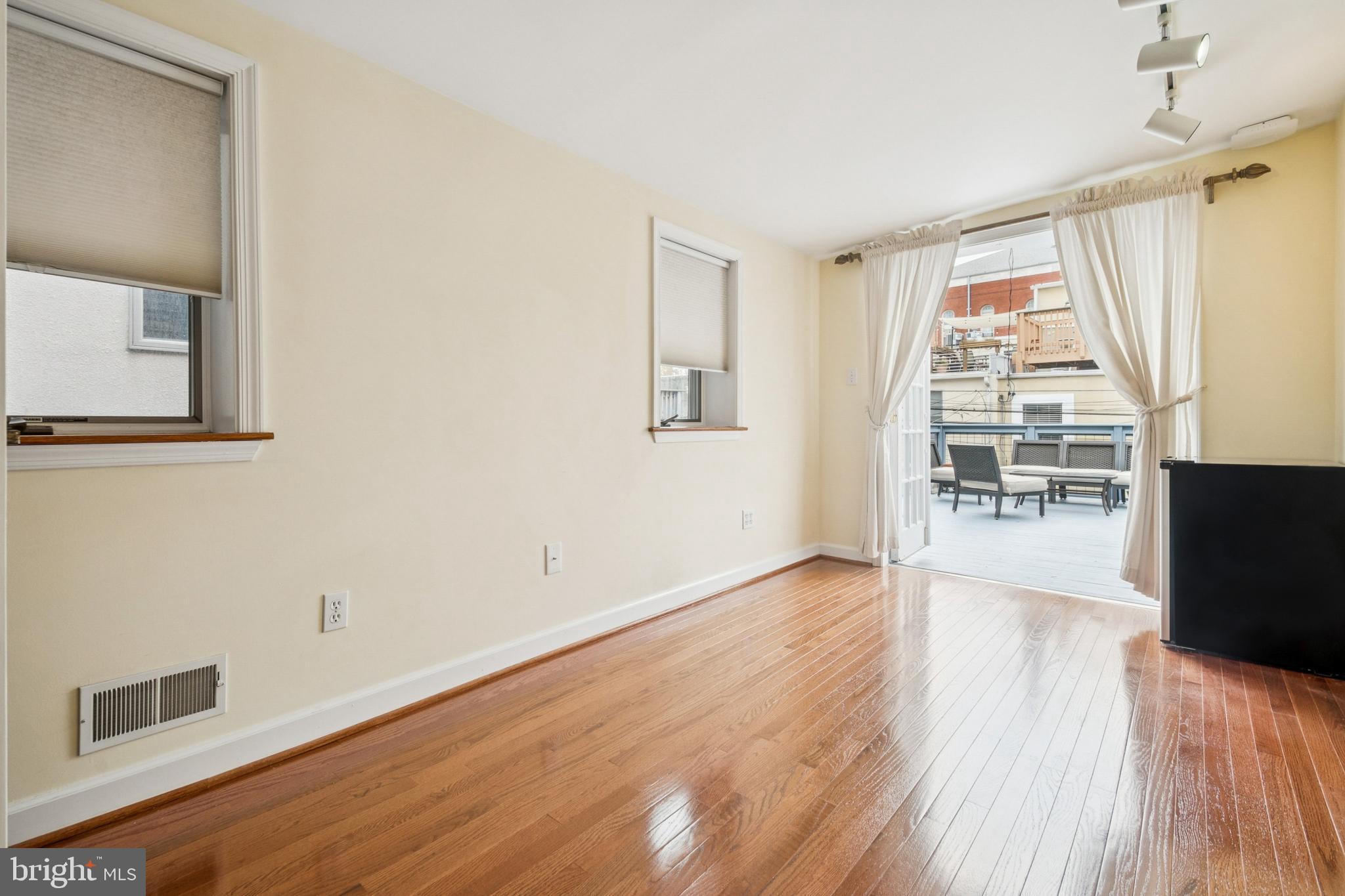 1134 Battery Avenue Baltimore, MD 21230 - Photo 11 of 30 a view of a big room with wooden floor and windows