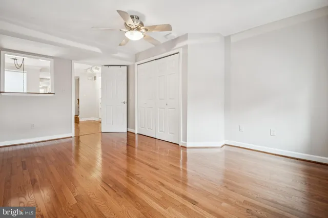 a view of an empty room with wooden floor