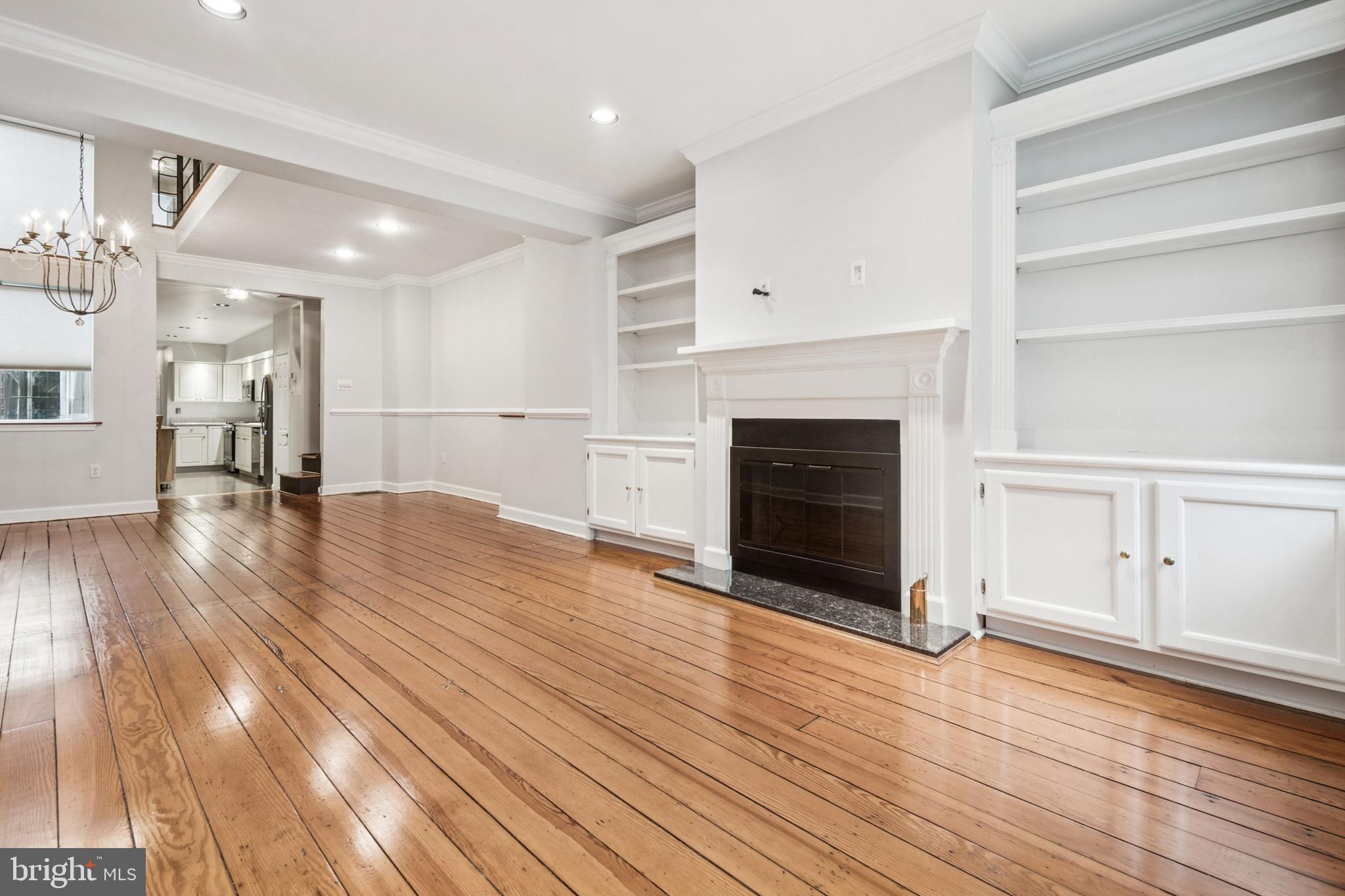 1134 Battery Avenue Baltimore, MD 21230 - Photo 2 of 30 a view of a livingroom with wooden floor and a kitchen space