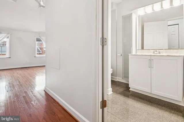 a view of a hallway with wooden floor and closet