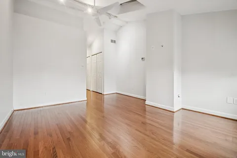 a view of an empty room with wooden floor