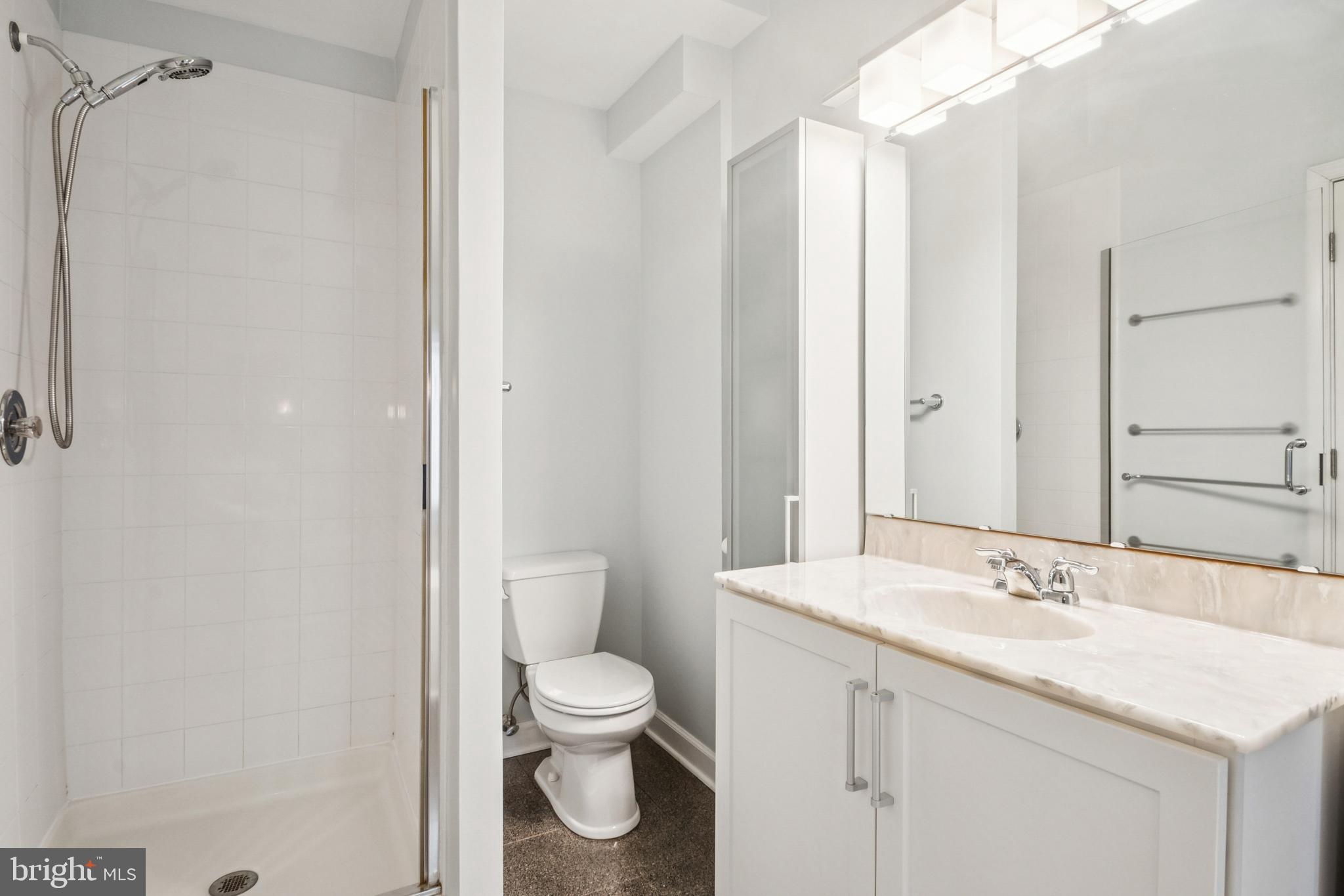 1134 Battery Avenue Baltimore, MD 21230 - Photo 23 of 30 a bathroom with a granite countertop sink toilet and shower