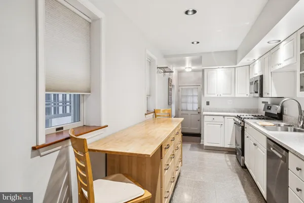 a kitchen that has a sink and a stove in it