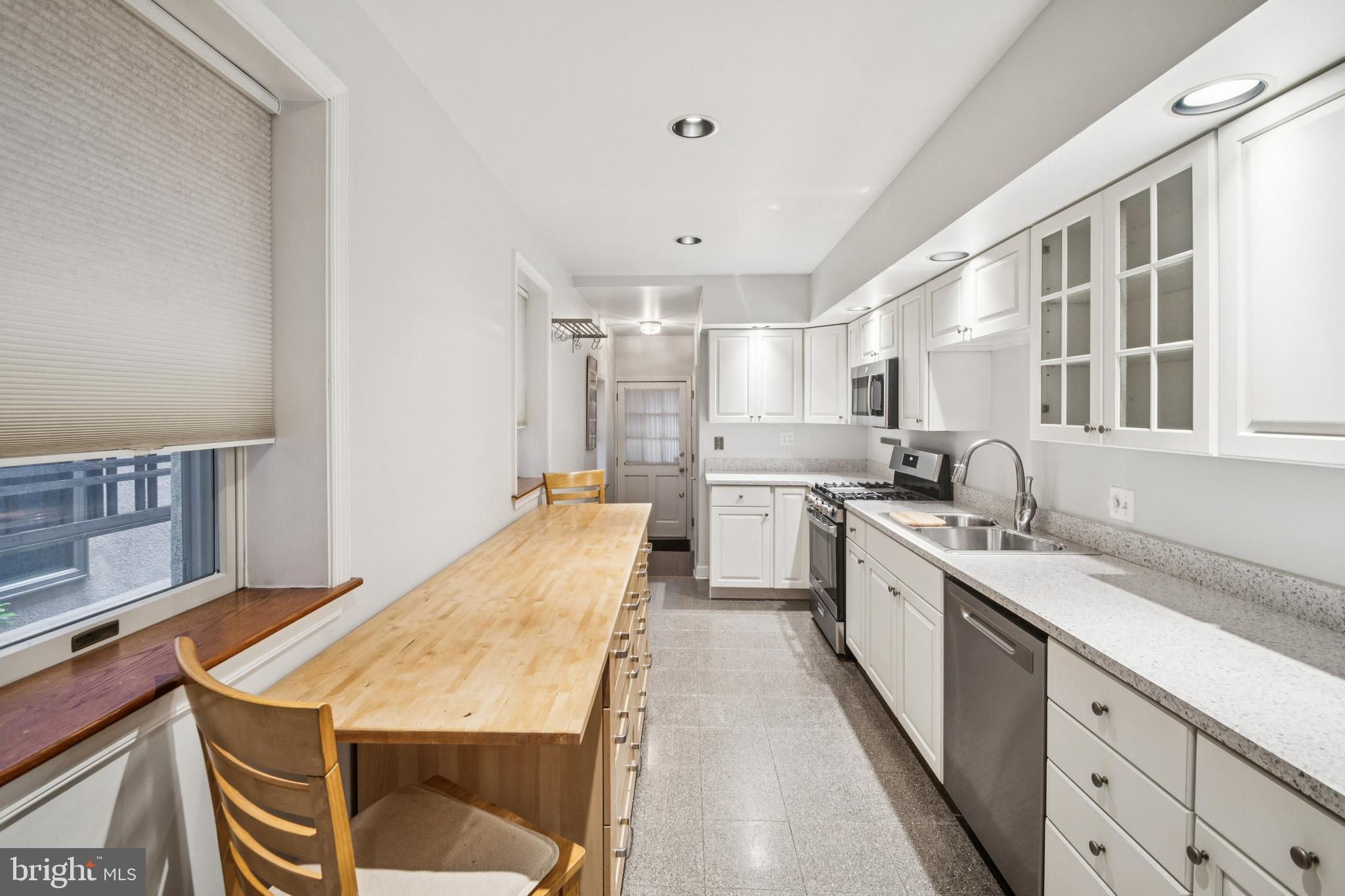1134 Battery Avenue Baltimore, MD 21230 - Photo 6 of 30 a kitchen with a stove a sink dishwasher and a refrigerator