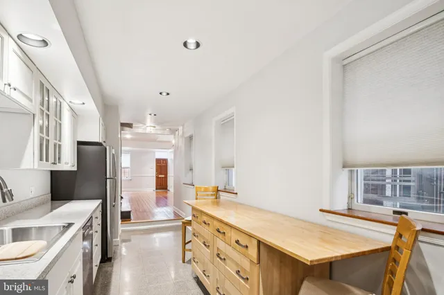 a spacious bathroom with a granite countertop sink a mirror and a shower