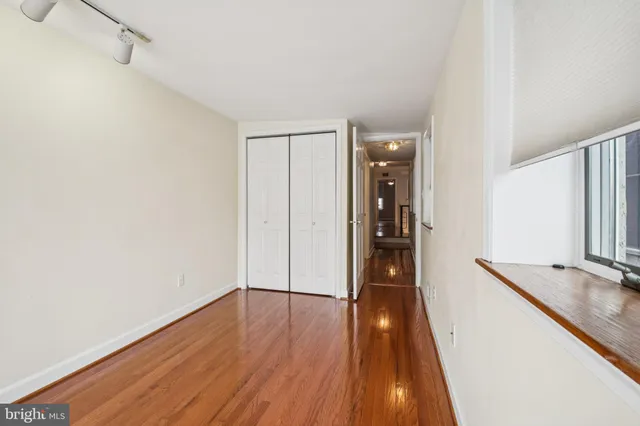 a view of a hallway view with wooden floor and staircase