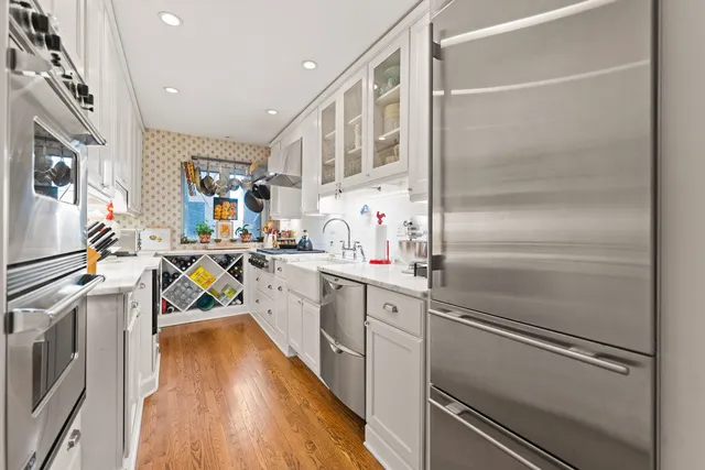 a kitchen with cabinets and stainless steel appliances