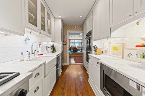 a bathroom with a sink and mirror with toilet