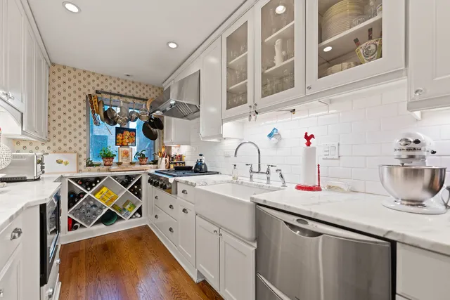 a kitchen with cabinets a sink and appliances