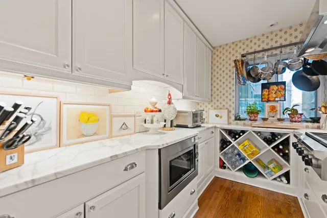 a view of a kitchen with stainless steel appliances granite countertop a sink and a stove