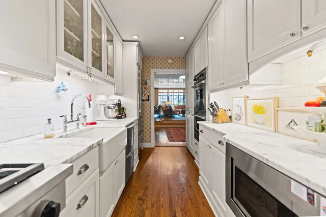 a kitchen with a sink stove top oven and cabinets