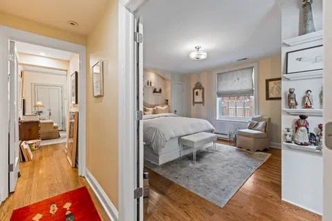 a bedroom with a bed and a painting on the wall