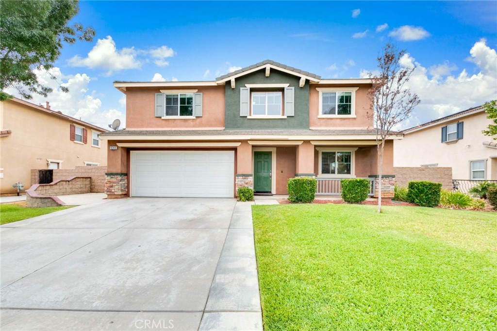 9249 San Rafael Archangel Lane Riverside, CA 92508 - Photo 1 of 1 a front view of a house with a yard and garage