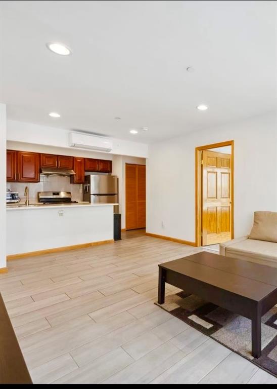 229 55th Street, Unit 2A Brooklyn, NY 11220 - Photo 5 of 12 a living room with stainless steel appliances kitchen island granite countertop furniture and a kitchen view