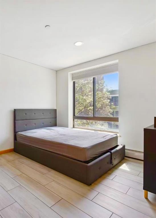229 55th Street, Unit 2A Brooklyn, NY 11220 - Photo 8 of 12 a bedroom with a bed and window