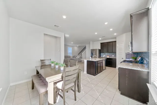 a kitchen with a sink a counter top space and stainless steel appliances