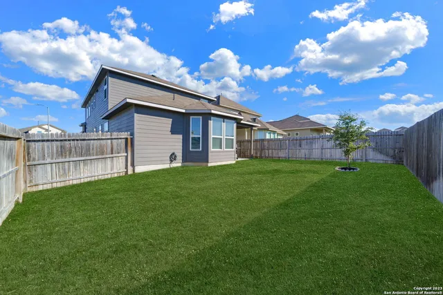 a backyard of a house with a garden and deck