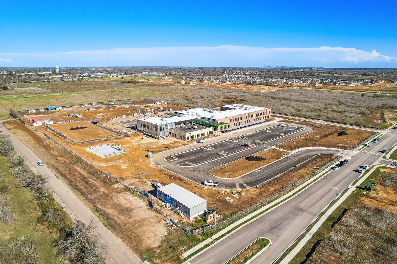 159 Hornet Street Elgin, TX 78621 - Photo 14 of 18 Vast acreage surrounds a contemporary community structure, offering ample space for future development.